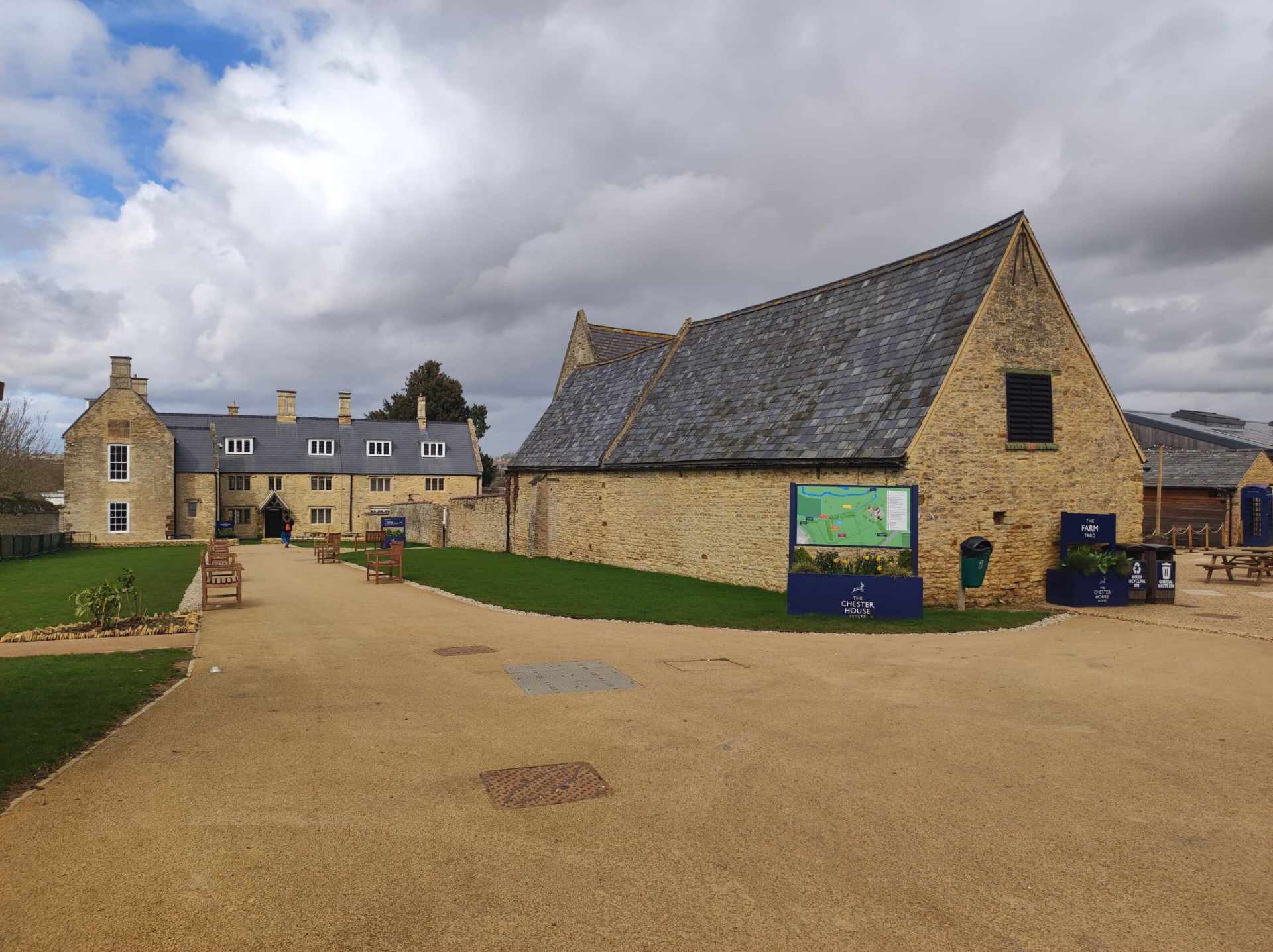 colour photo of exterior of some buildings at Chester House Estate on a dirt path