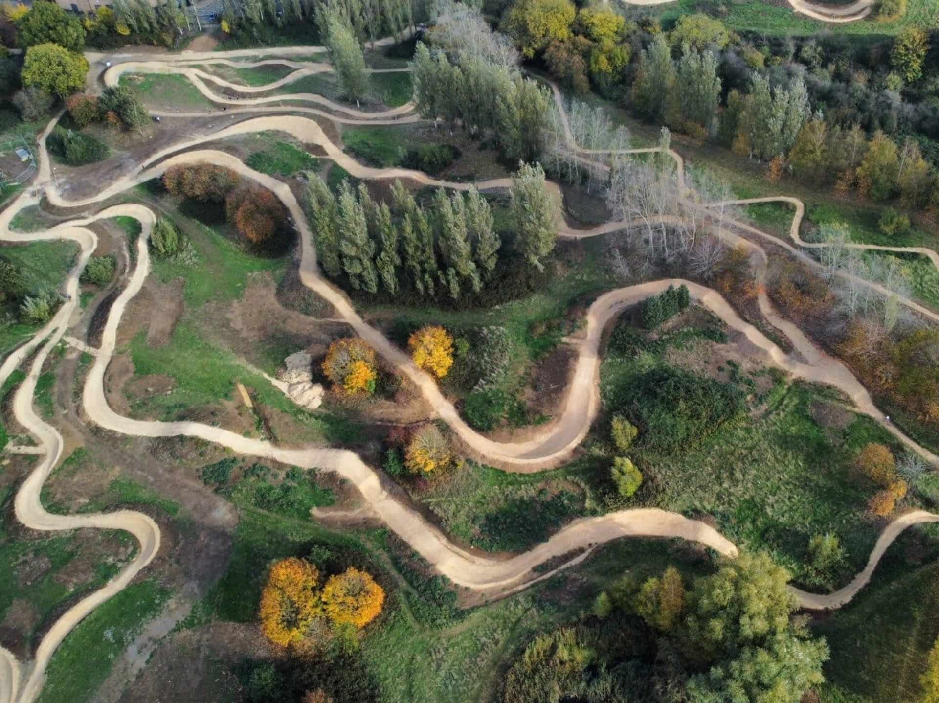 colour aerial photo of Northampton Bike Park, showing the hilly, green landscape and winding dirt track from above